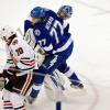 TAMPA, FL - JUNE 13:  Ben Bishop #30 of the Tampa Bay Lightning collides with Victor Hedman #77 as Patrick Sharp #10 of the Chicago Blackhawks skates past them with the puck on his way to scoring a goal in the first period Game Five of the 2015 NHL Stanley Cup Final at Amalie Arena on June 13, 2015 in Tampa, Florida.  (Photo by Mike Carlson/Getty Images)