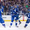 TAMPA, FL - APRIL 29: Ryan Callahan #24 jumps into the arms of teammate Braydon Coburn #55 of the Tampa Bay Lightning as they celebrate a goal with teammates Steven Stamkos #91 and Jason Garrison #5 against the Detroit Red Wings during the third period of Game Seven of the Eastern Conference Quarterfinals during the 2015 NHL Stanley Cup Playoffs at the Amalie Arena on April 29, 2015 in Tampa, Florida.  (Photo by Scott Audette/NHLI via Getty Images)