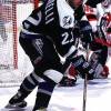 2000 Season: Tampa's Dino Ciccarelli moves puck along side the New Jersey net.  (Photo by Jim Leary/Getty Images)