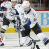 RALEIGH, NC - OCTOBER 06:  Drew Miller #16 of the Tampa Bay Lightning skates the puck into the defensive zone of the Carolina Hurricanes during a NHL game on October 6, 2009 at RBC Center in Raleigh, North Carolina. The Huricanes defeated the Lightning 3-1.  (Photo by Gregg Forwerck/NHLI via Getty Images)