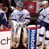 WASHINGTON, DC - March 8, 2012:  Tampa Bay Lightning goalie Dustin Tokarski (#40) sits on the bench drinking water and speaking to the team trainer during the intermission between the third period and overtime of their their NHL ice hockey game at Verizon Center against the Washington Capitals. The game was Tokarksi's first NHL career start and he became dehydrated late, requiring 2 units of sodium chloride after the game according to Damian Cristodero of the Tampa Bay Times.