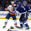 TAMPA, FLORIDA - JUNE 21:  Matt Martin #17 of the New York Islanders and Luke Schenn #2 of the Tampa Bay Lightning fight during the second period in Game Five of the Stanley Cup Semifinals during the 2021 Stanley Cup Playoffs at Amalie Arena on June 21, 2021 in Tampa, Florida. (Photo by Mike Carlson/Getty Images)