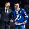 TAMPA, FL - NOVEMBER 25: Martin St. Louis #26 of the Tampa Bay Lightning is presented with a silver stick commemorating his 1,000th NHL game by Tampa Bay Lightning General Manager Steve Yzerman during the pre game ceremony prior to the game against the New York Rangers at the Tampa Bay Times Forum on November 25, 2013 in Tampa, Florida.  (Photo by Scott Audette/NHLI via Getty Images)