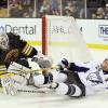 BOSTON, MA - MARCH 03:  Tim Thomas #30 of the Boston Bruins stops a shot as Martin St. Louis #26 of the Tampa Bay Lightning runs into him in the second period on March 3, 2011 at the TD Garden in Boston, Massachusetts.  (Photo by Elsa/Getty Images)