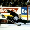 Canadiens forward Mark Recchi #8 shoots at an open net as goaltender Rick Tabaracci #31 dives back into his  crease in  a game at the Molson Centre during the 1996-97 season (Photo by Denis Brodeur/NHLI via Getty Images)