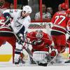 RALEIGH, NC - JANUARY 18: Ryan Malone #12 of the Tampa Bay Lightning backhands the puck between the pads of Cam Ward #30 of the Carolina Hurricanes during a NHL game on January 18, 2010 at RBC Center in Raleigh, North Carolina.  (Photo by Gregg Forwerck/NHLI via Getty Images)