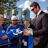 TAMPA, FL - OCTOBER 10:  Ryan Malone #12 of the Tampa Bay Lightning signs autographs as he arrives for the team's home opening game against the Florida Panthers at the Tampa Bay Times Forum on October 10, 2013 in Tampa, Florida. (Photo by Mike Carlson/Getty Images)