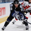 TAMPA, FL - OCTOBER 8:  Mike Mottau #27 of the New Jersey Devils tries to catch Stephane Veilleux #19 of the Tampa Bay Lightning as he chases down the puck at the St. Pete Times Forum on October 8, 2009 in Tampa, Florida.  (Photo by Scott Audette/NHLI via Getty Images)